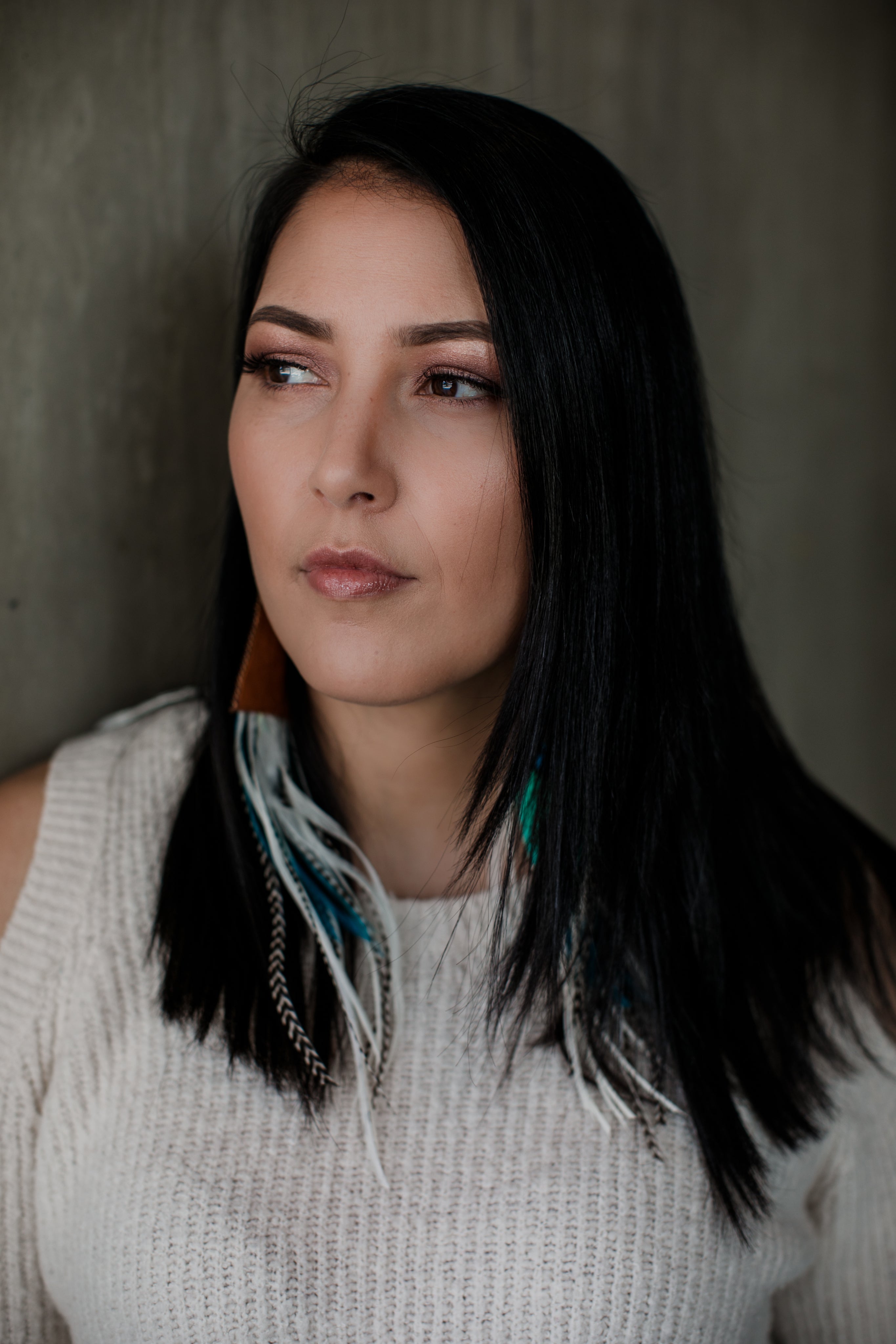 files/portrait-of-woman-wearing-long-feather-earrings.jpg